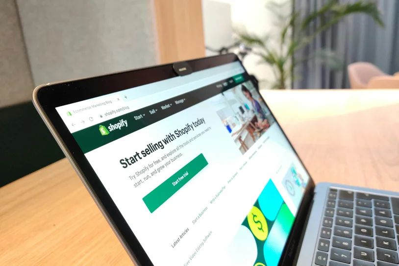 Laptop screen showing a Shopify start selling online landing page