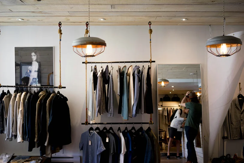 Customer browsing clothing racks inside a small independent boutique